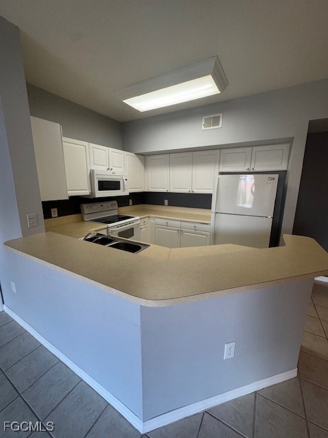 15625 Ocean Walk Circle, Unit 309 Fort Myers, FL 33908 - Photo 5 of 16 a kitchen with kitchen island cabinets and refrigerator