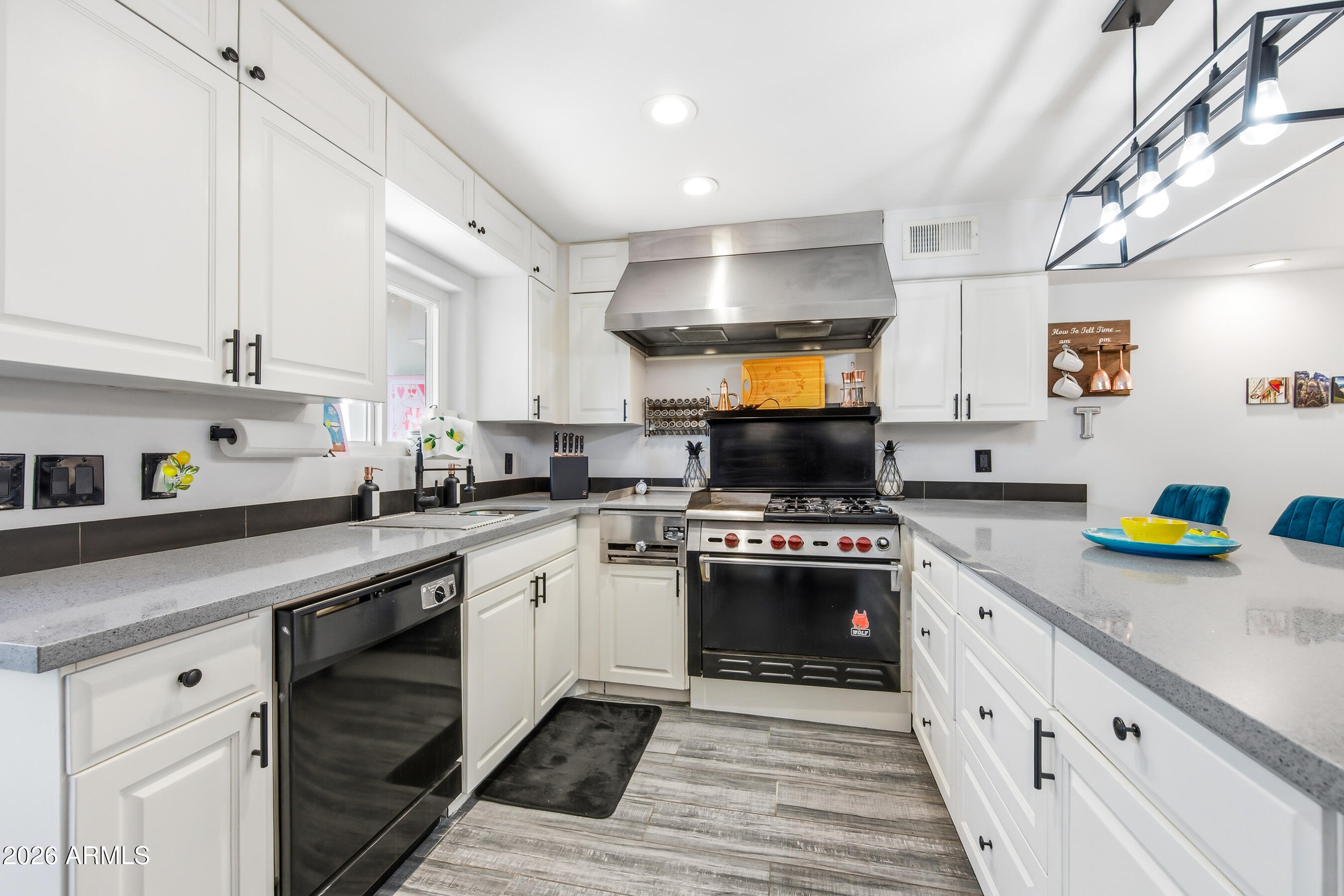 1702 East Ocotillo Road, Unit 1 Phoenix, AZ 85016 - Photo 9 of 27 a kitchen with sink a stove and cabinets