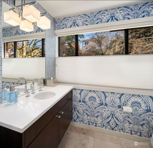 a bathroom with a sink mirror and vanity