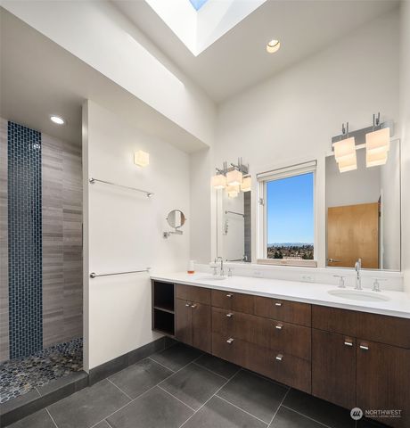 a bathroom with a double vanity sink and mirror