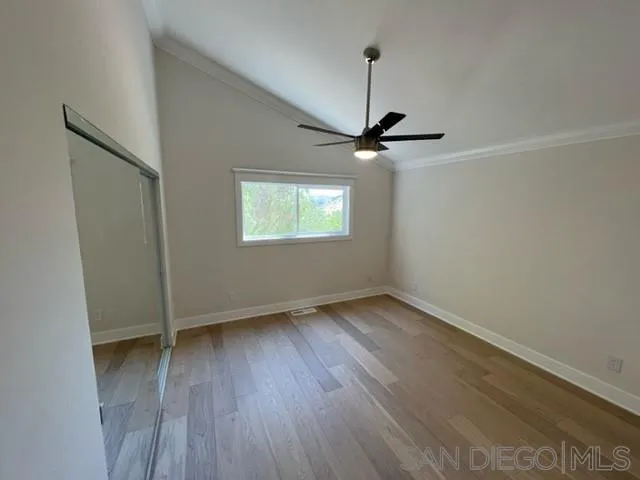 3139 Mt Whitney Road Escondido, CA 92029 - Photo 6 of 20 an empty room with wooden floor fan and windows