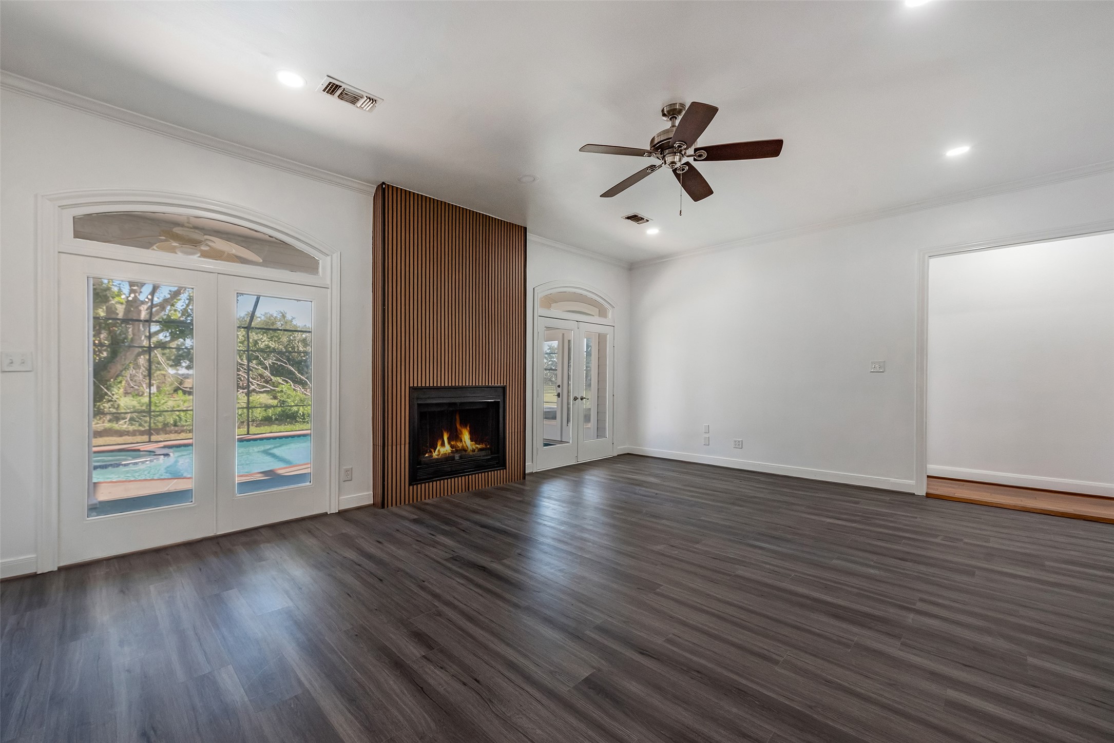 4610 Lea Lane Fulshear, TX 77406 - Photo 13 of 50 a view of empty room with wooden floor and fireplace