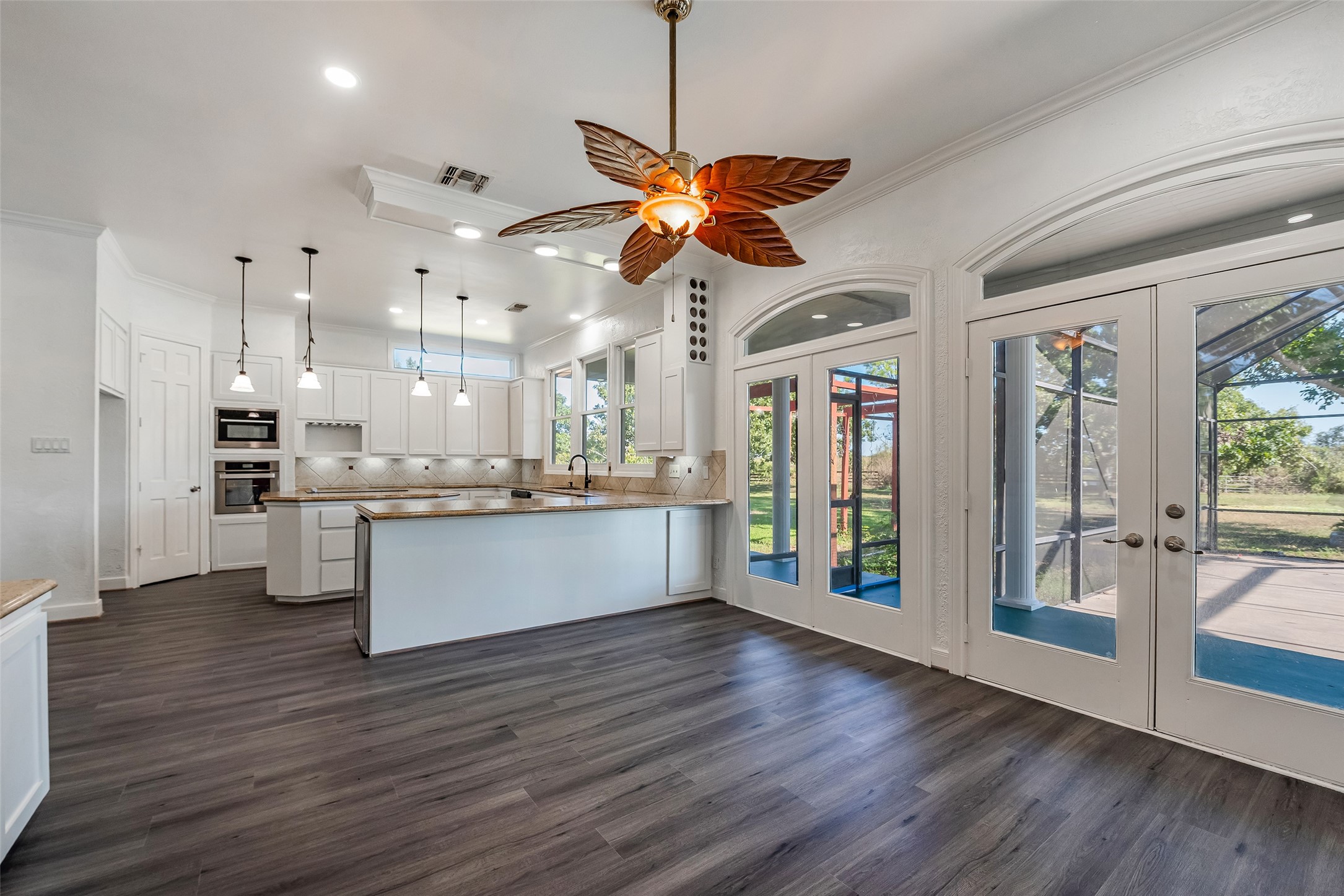 4610 Lea Lane Fulshear, TX 77406 - Photo 14 of 50 a view of a kitchen with wooden floor and a window
