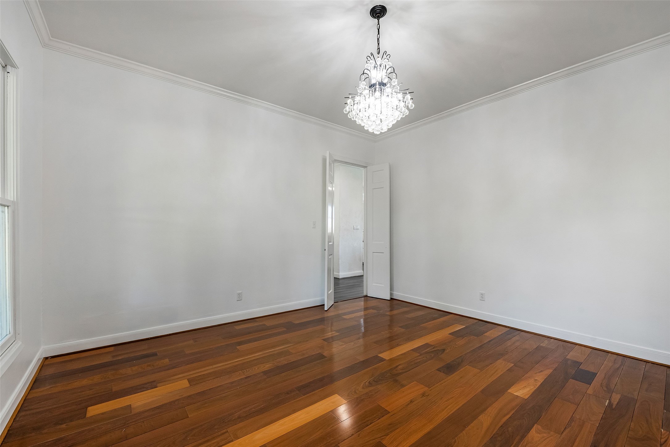4610 Lea Lane Fulshear, TX 77406 - Photo 25 of 50 a view of an empty room with wooden floor and a window