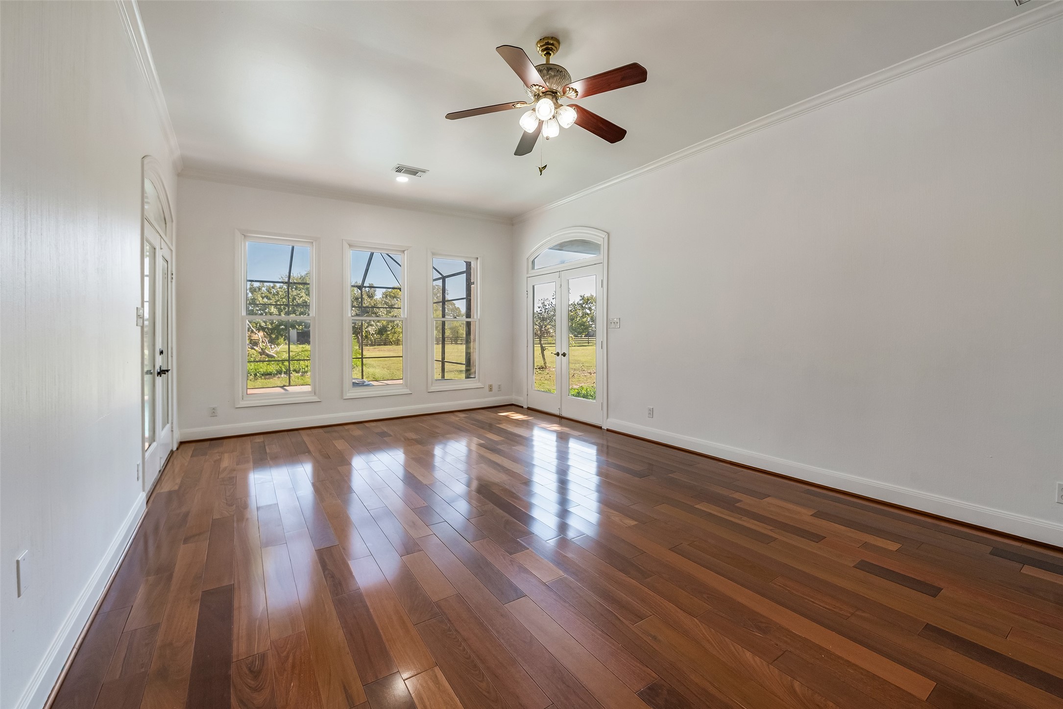 4610 Lea Lane Fulshear, TX 77406 - Photo 26 of 50 a view of an empty room with window and wooden floor