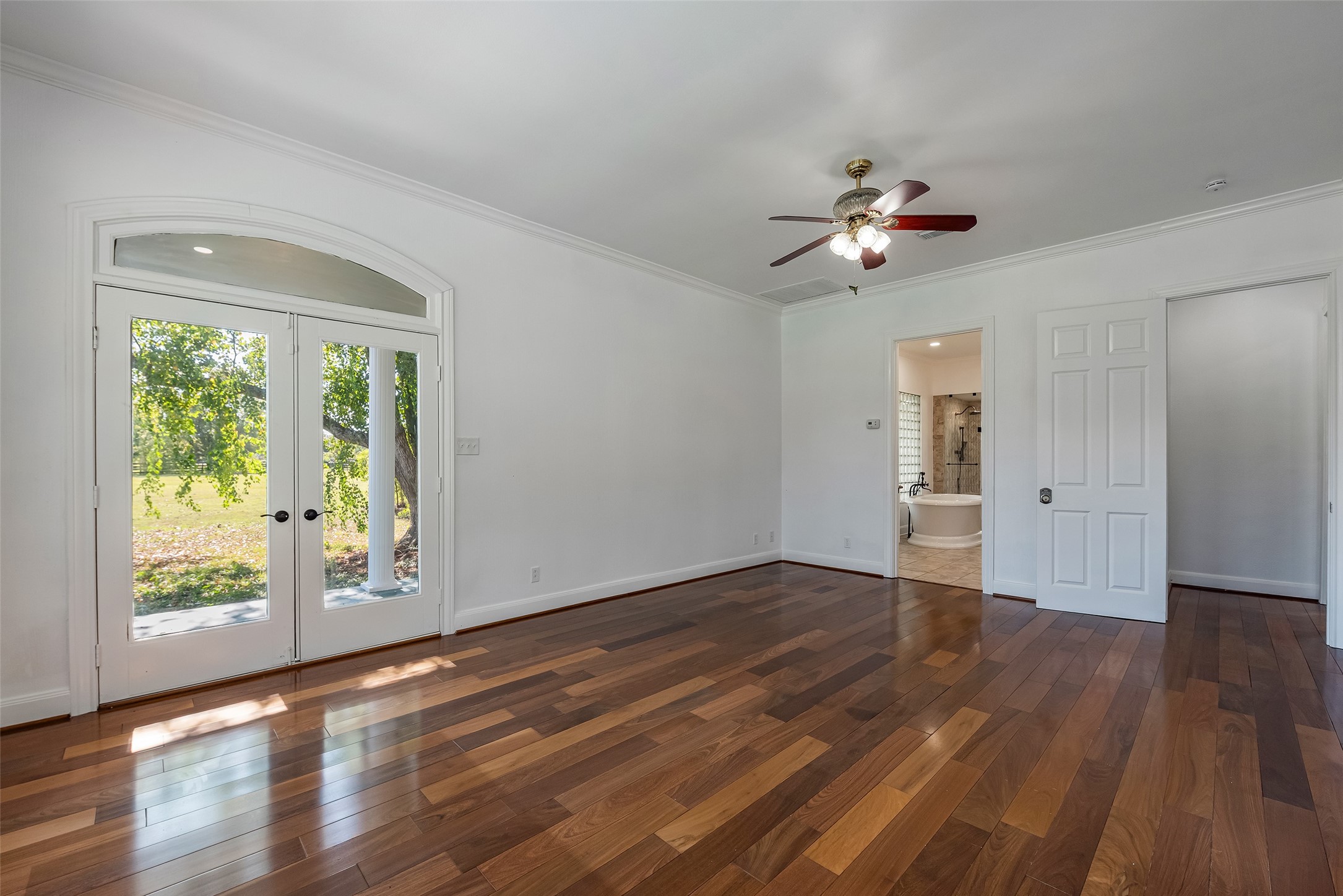 4610 Lea Lane Fulshear, TX 77406 - Photo 27 of 50 a view of empty room with wooden floor and fan