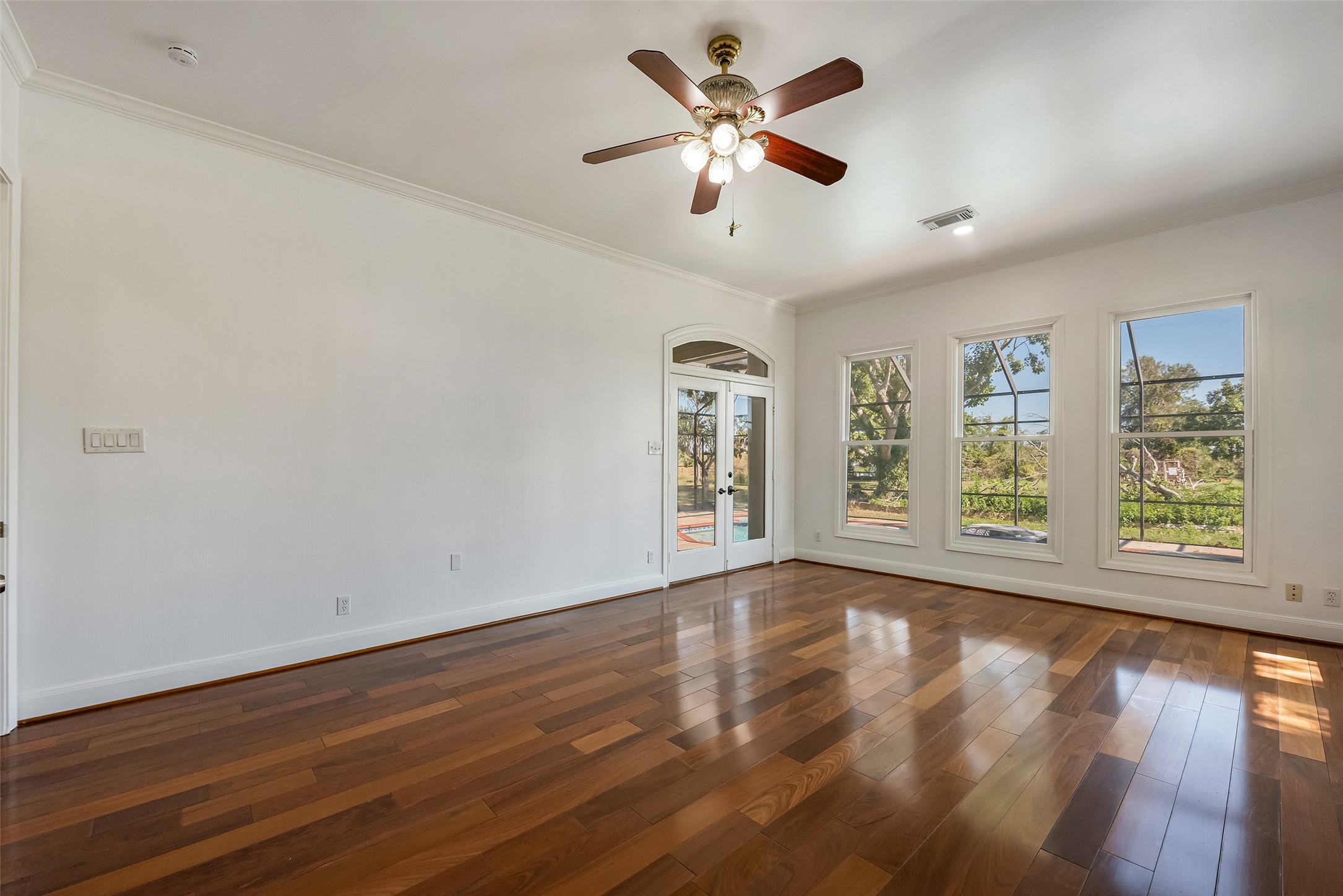 4610 Lea Lane Fulshear, TX 77406 - Photo 29 of 50 a view of an empty room with a window and wooden floor