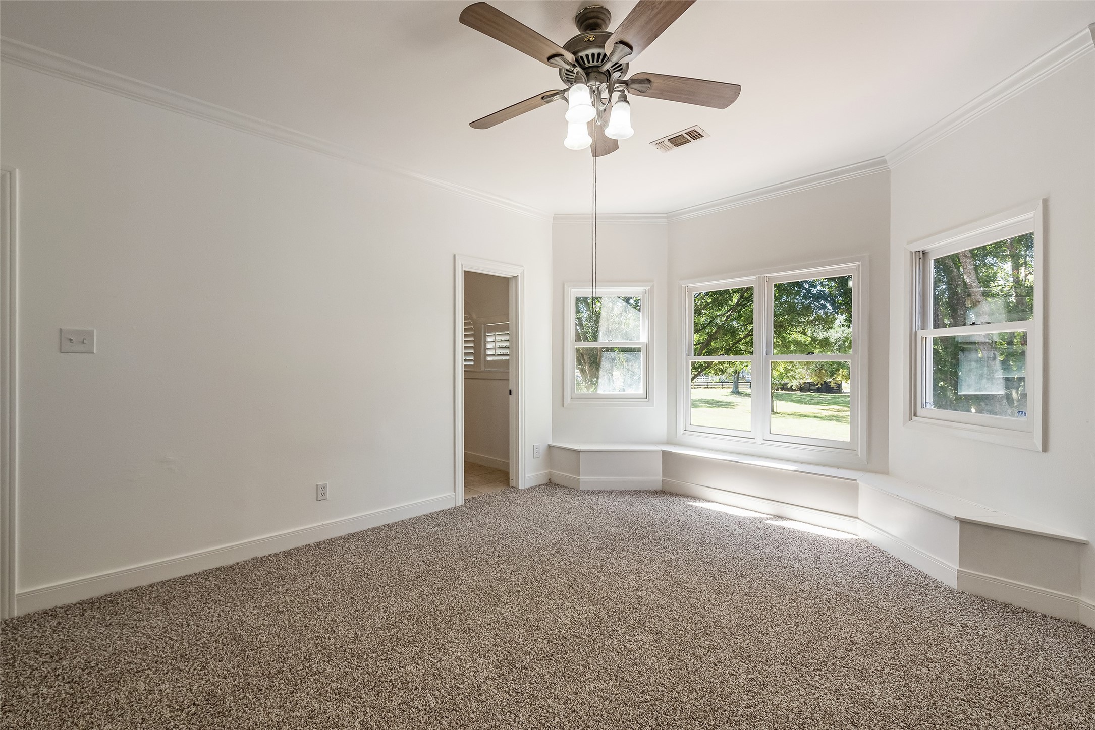 4610 Lea Lane Fulshear, TX 77406 - Photo 32 of 50 an empty room with chandelier fan and windows