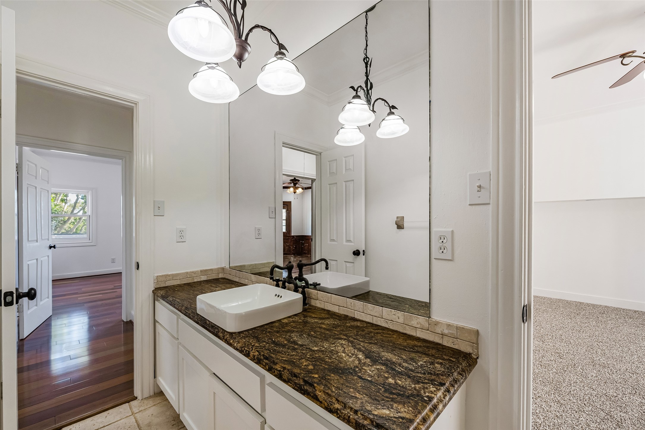 4610 Lea Lane Fulshear, TX 77406 - Photo 34 of 50 a view of a kitchen with a sink granite counter tops and a chandelier