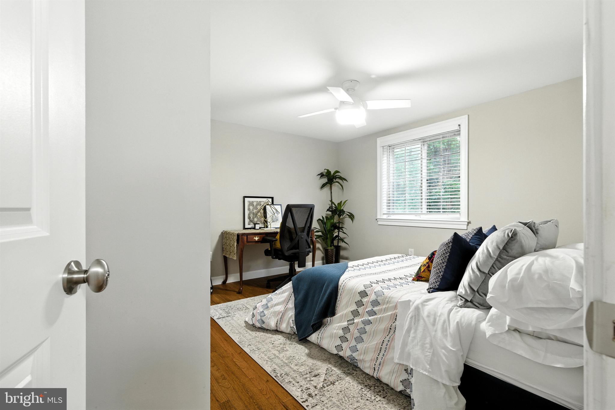 21804 Goshen School Road Gaithersburg, MD 20882 - Photo 14 of 37 a bedroom with a bed and ceiling fan