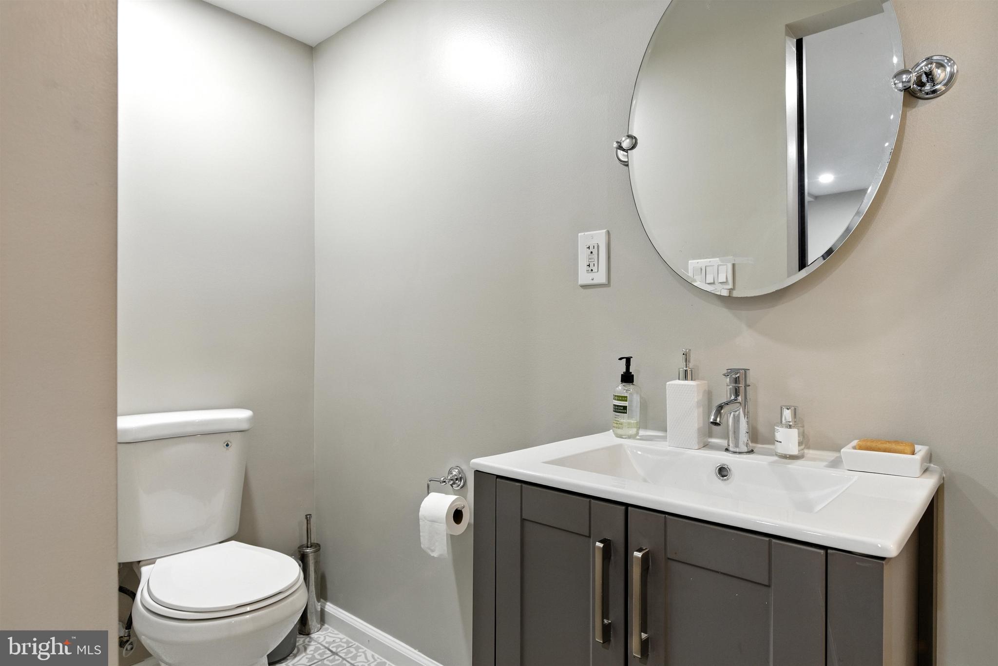 21804 Goshen School Road Gaithersburg, MD 20882 - Photo 20 of 37 a bathroom with a sink a toilet and a mirror