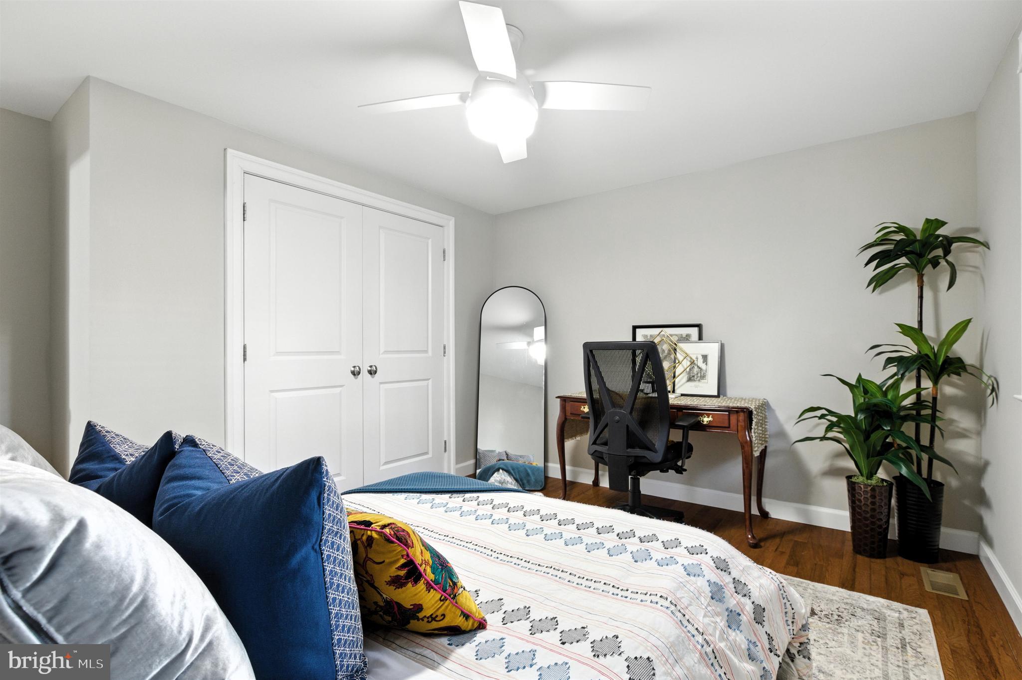 21804 Goshen School Road Gaithersburg, MD 20882 - Photo 24 of 37 a bedroom with a bed and a chandelier