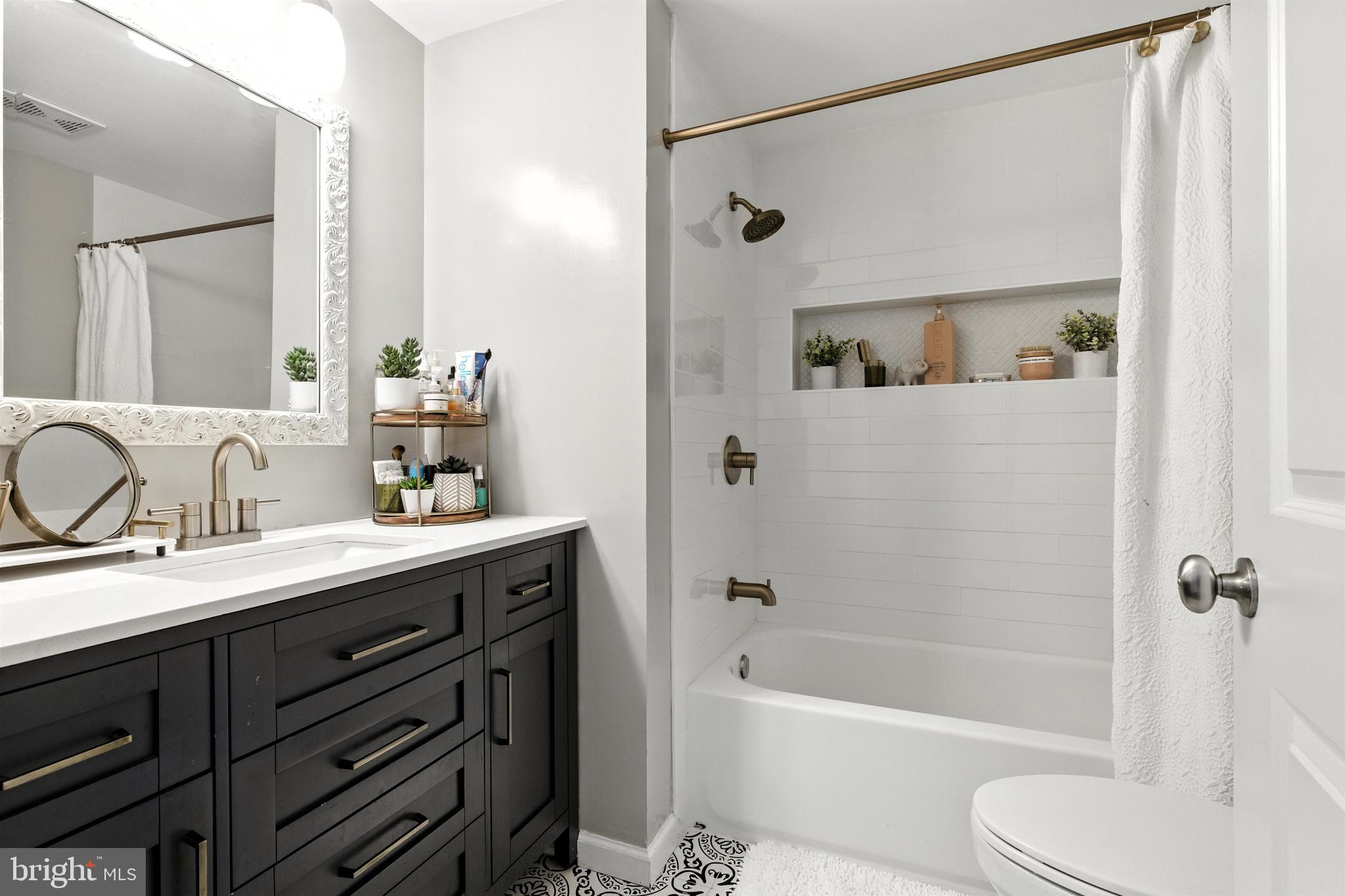 21804 Goshen School Road Gaithersburg, MD 20882 - Photo 28 of 37 a bathroom with a tub sink toilet and a mirror