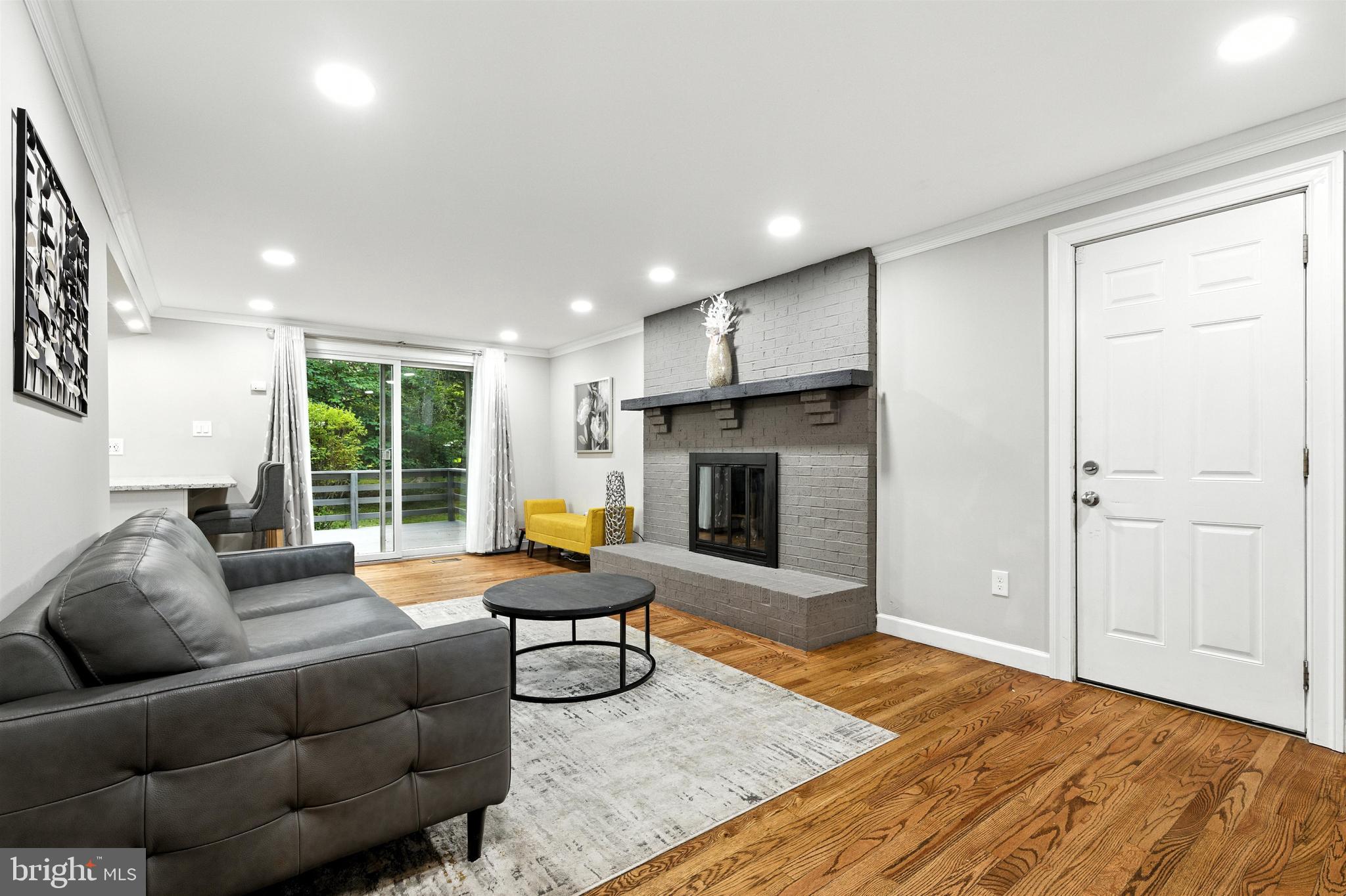 21804 Goshen School Road Gaithersburg, MD 20882 - Photo 29 of 37 a living room with furniture and a fireplace