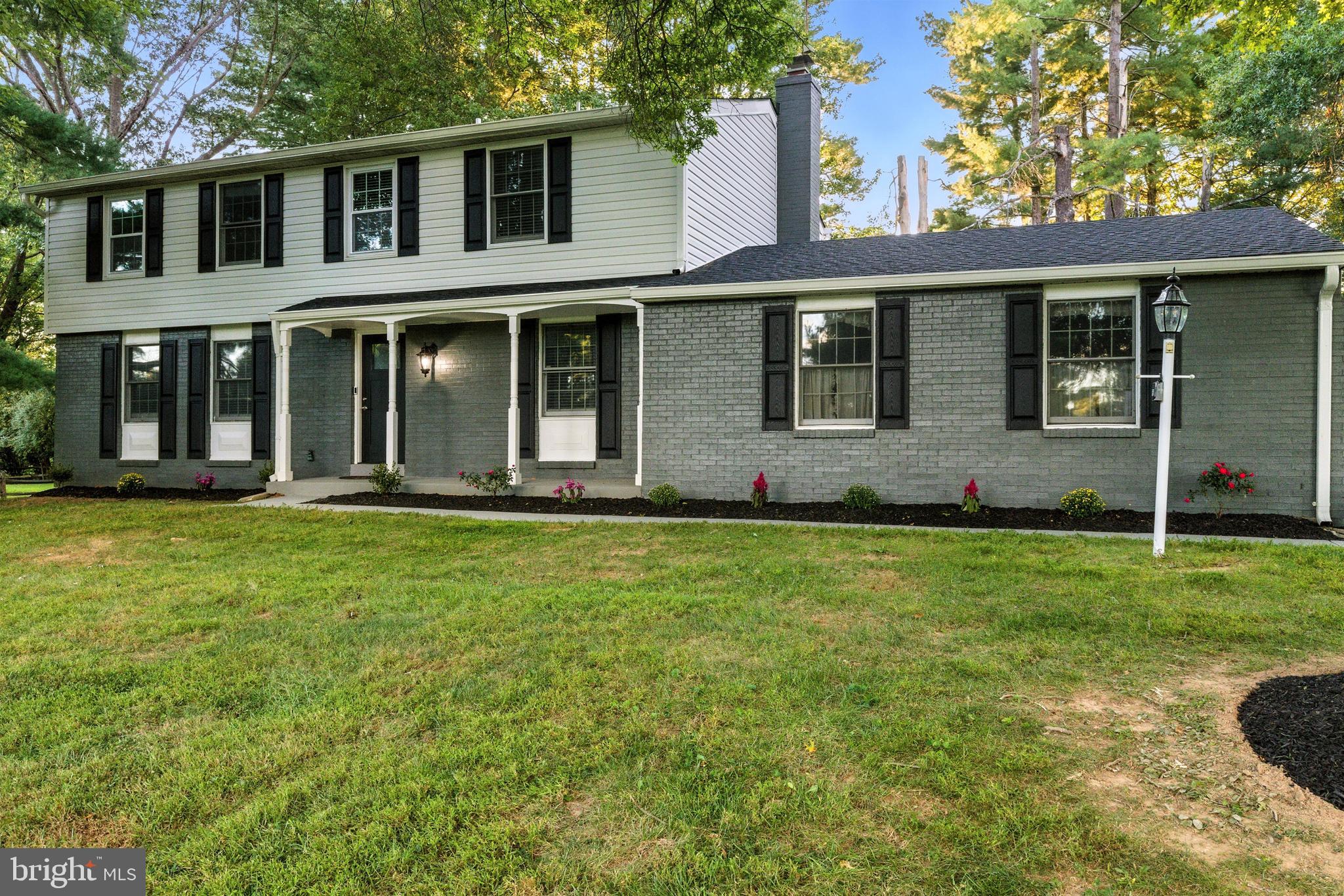 21804 Goshen School Road Gaithersburg, MD 20882 - Photo 31 of 37 a front view of a house with a garden