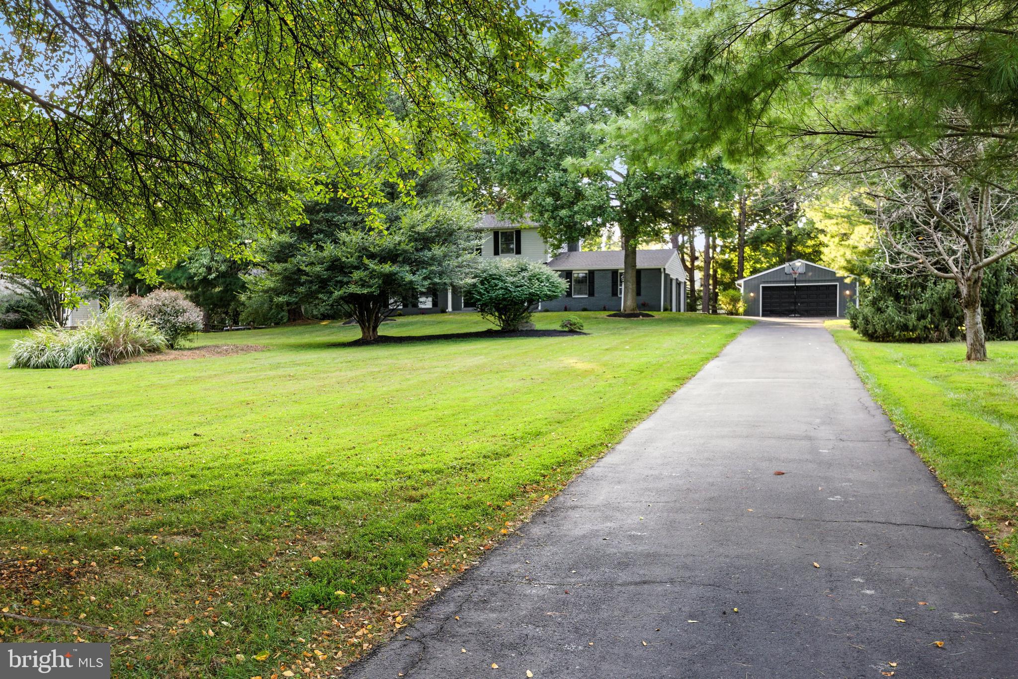 21804 Goshen School Road Gaithersburg, MD 20882 - Photo 33 of 37 a front view of a house with a yard and trees