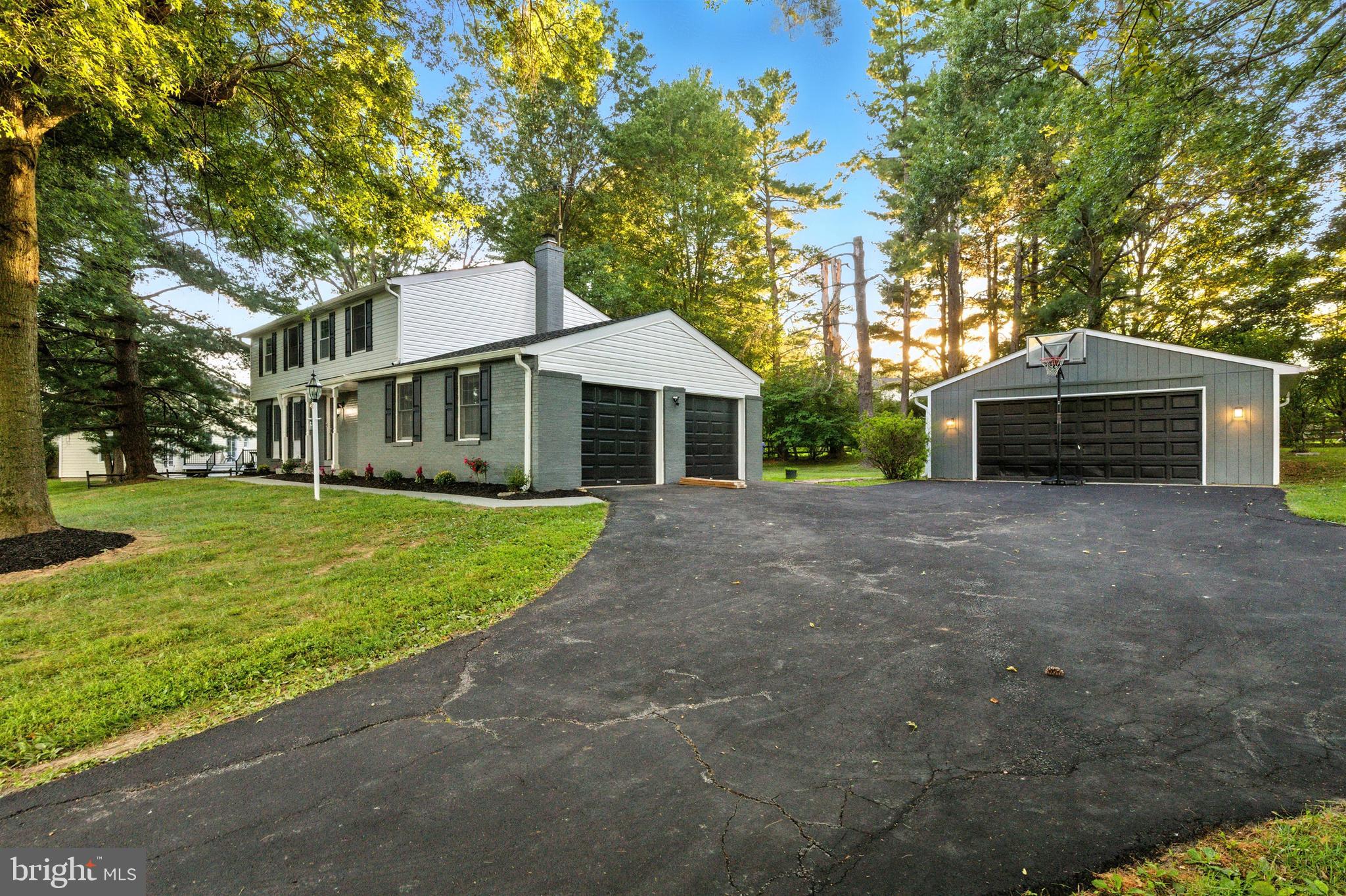 21804 Goshen School Road Gaithersburg, MD 20882 - Photo 35 of 37 a front view of a house with a yard and garage
