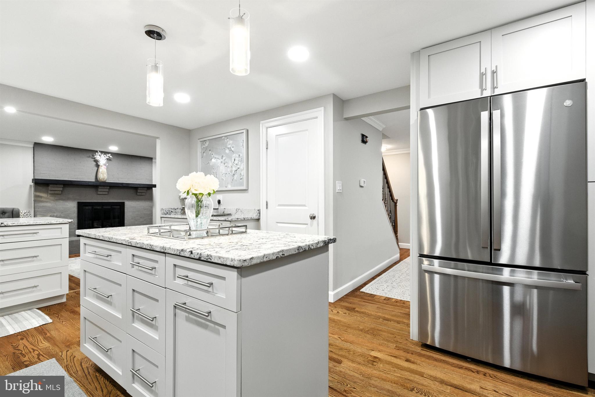 21804 Goshen School Road Gaithersburg, MD 20882 - Photo 7 of 37 a kitchen with kitchen island a counter top space wooden floor and stainless steel appliances