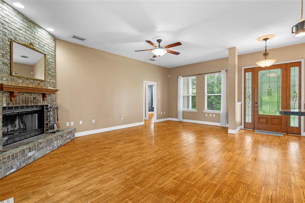 4405 North Wilder Road Plant City, FL 33565 - Photo 12 of 78 a view of an empty room with a fireplace and a window
