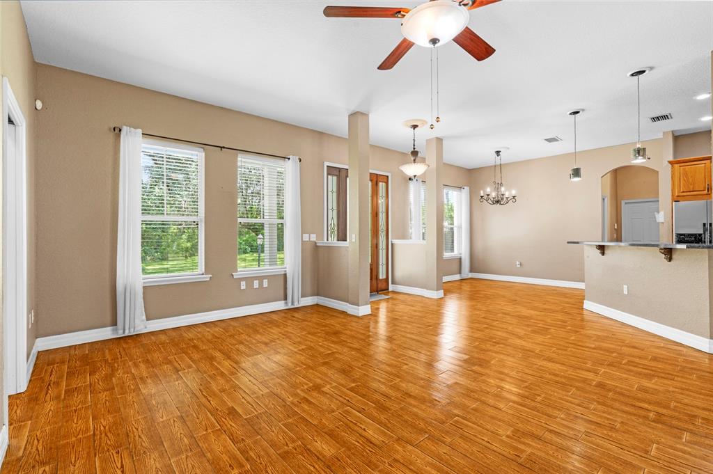 4405 North Wilder Road Plant City, FL 33565 - Photo 14 of 78 a view of an empty room with window and wooden floor