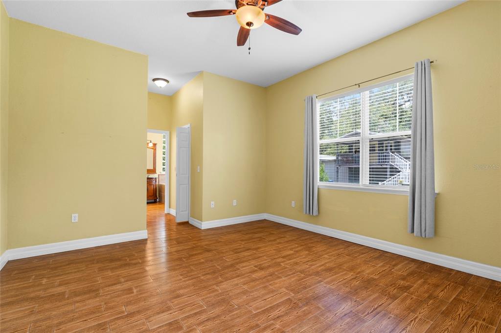 4405 North Wilder Road Plant City, FL 33565 - Photo 16 of 78 a view of empty room with wooden floor and fan