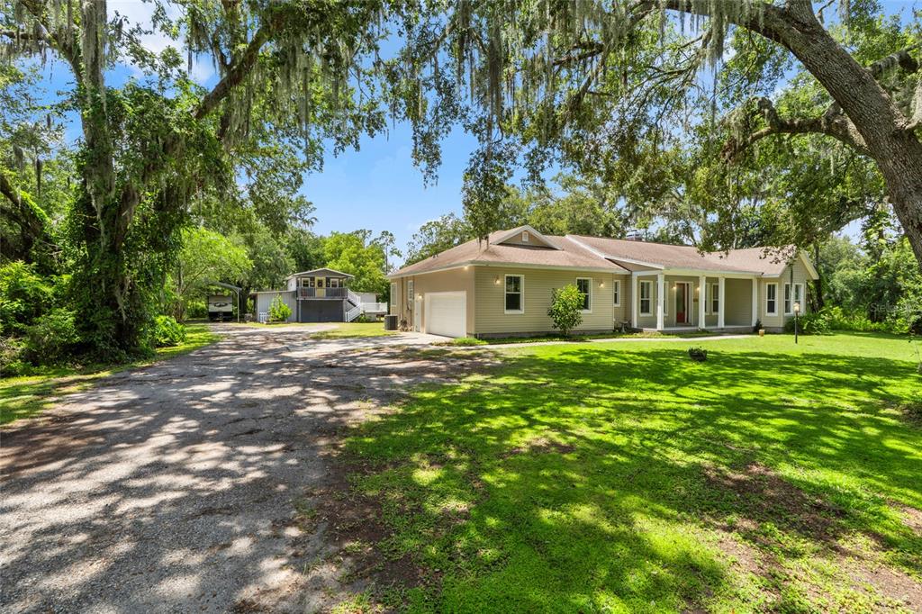 4405 North Wilder Road Plant City, FL 33565 - Photo 2 of 78 a house view with a garden space