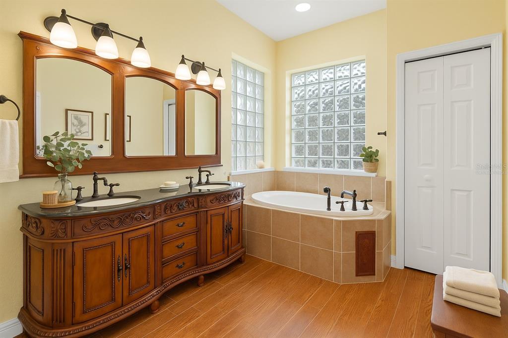 4405 North Wilder Road Plant City, FL 33565 - Photo 21 of 78 a spacious bathroom with a tub sink and mirror