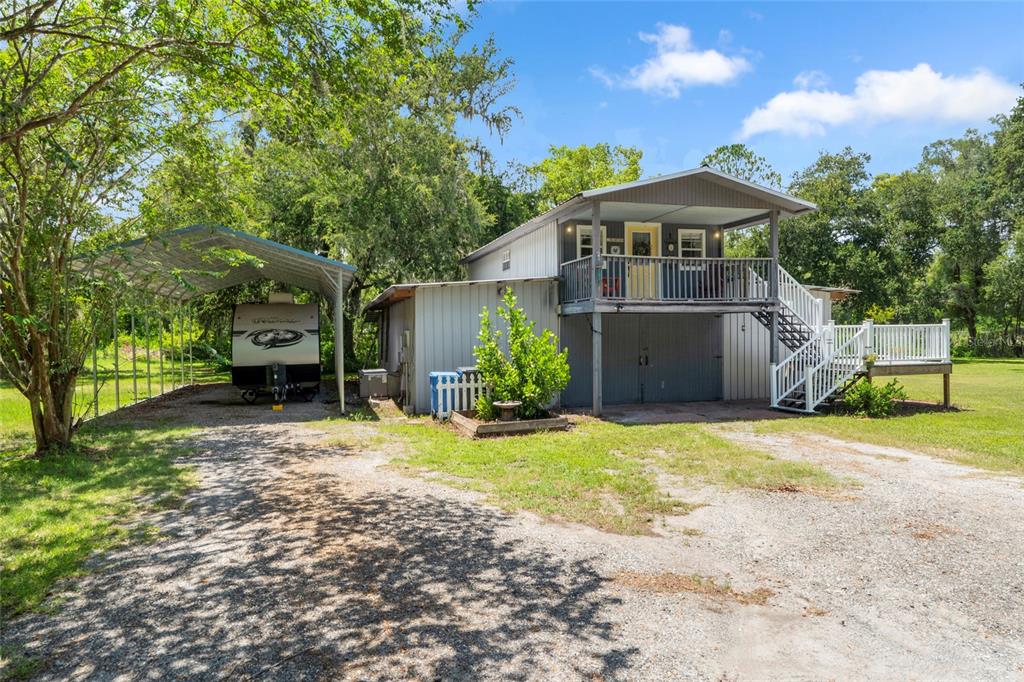 4405 North Wilder Road Plant City, FL 33565 - Photo 3 of 78 a front view of a house with garden