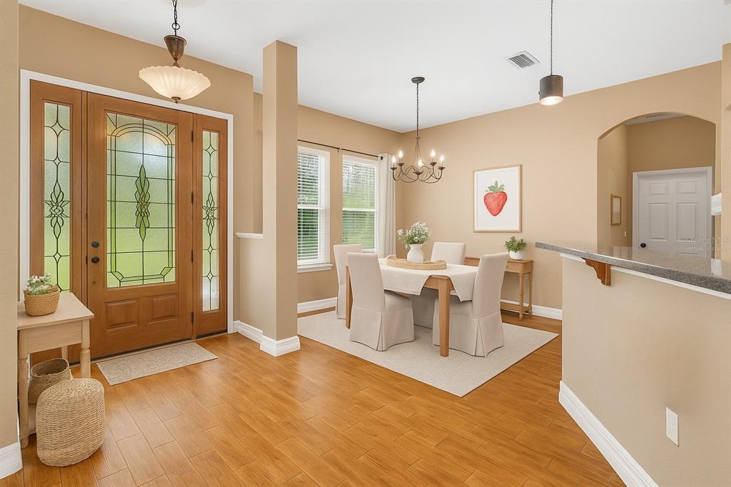 4405 North Wilder Road Plant City, FL 33565 - Photo 44 of 78 a living room with furniture a dining table and a chandelier