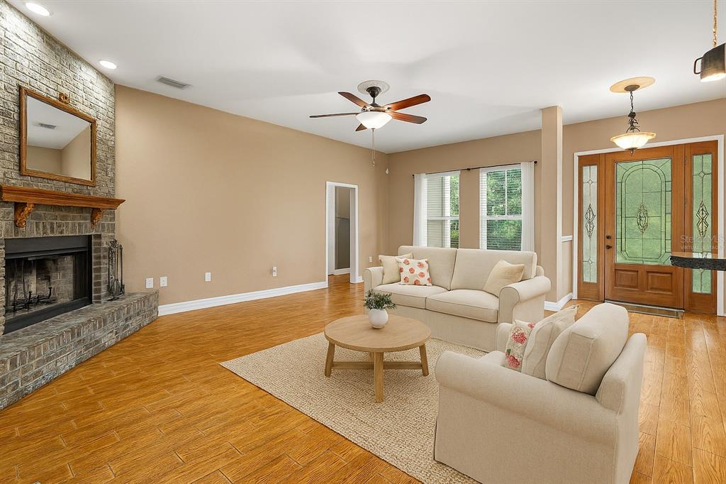 4405 North Wilder Road Plant City, FL 33565 - Photo 46 of 78 a living room with furniture a fireplace and a flat screen tv