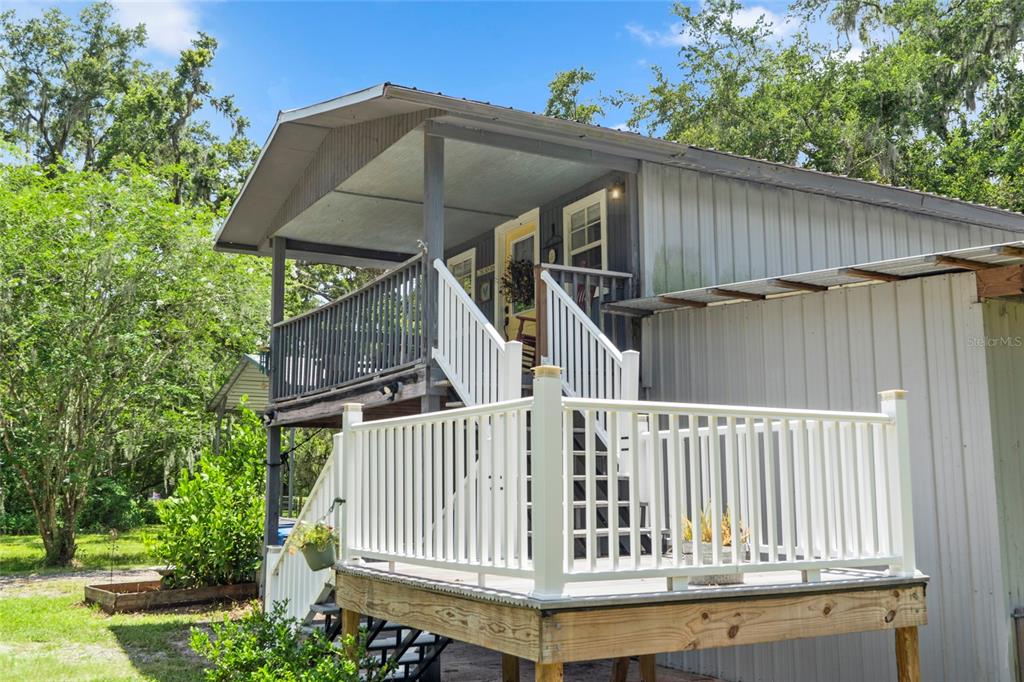 4405 North Wilder Road Plant City, FL 33565 - Photo 55 of 78 a view of a small house with wooden deck