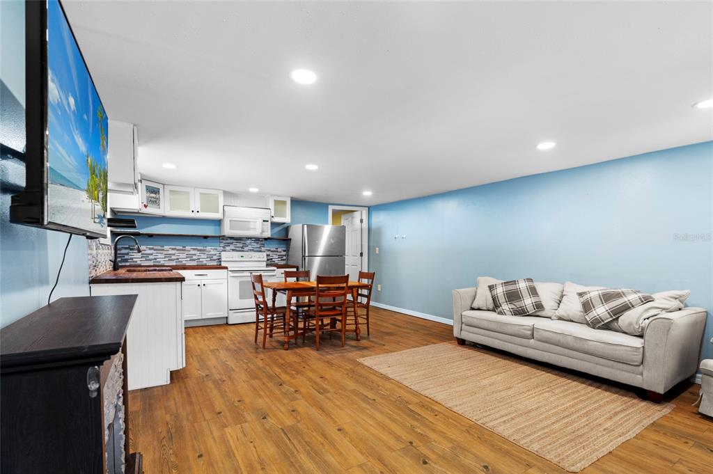 4405 North Wilder Road Plant City, FL 33565 - Photo 58 of 78 a living room with stainless steel appliances kitchen island granite countertop furniture and a wooden floor