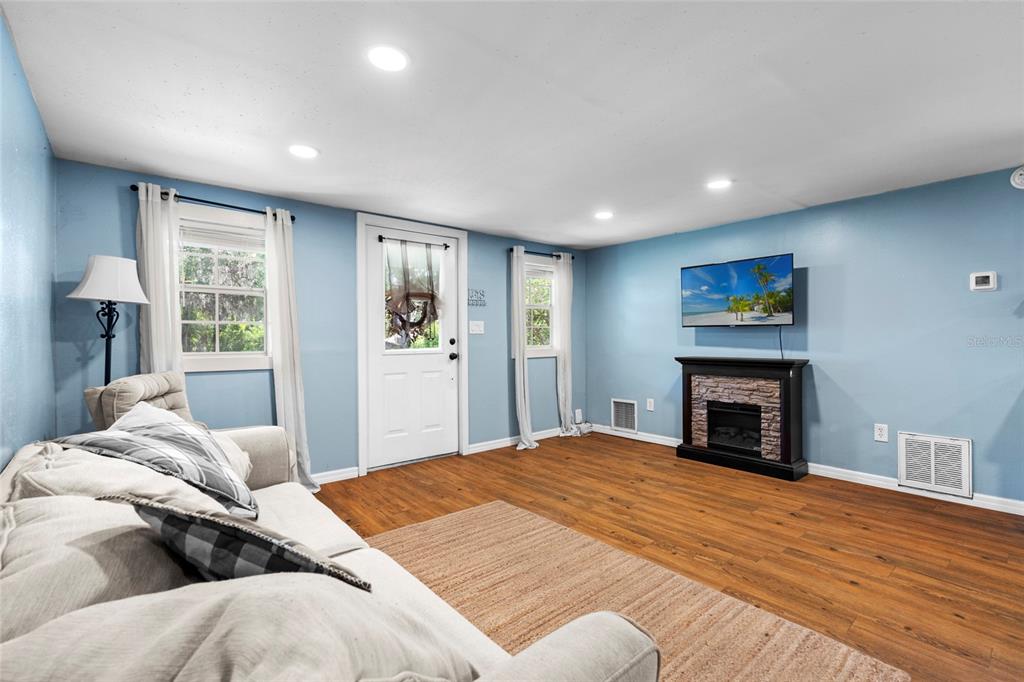 4405 North Wilder Road Plant City, FL 33565 - Photo 60 of 78 a bedroom with a large bed and a fireplace