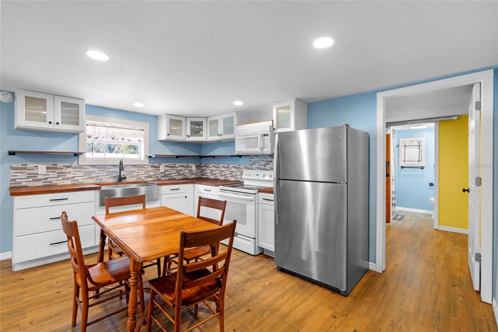 4405 North Wilder Road Plant City, FL 33565 - Photo 62 of 78 a kitchen with stainless steel appliances granite countertop a refrigerator and a stove top oven