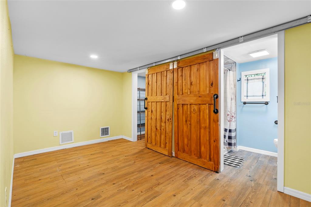 4405 North Wilder Road Plant City, FL 33565 - Photo 63 of 78 a view of an empty room with wooden floor and a window