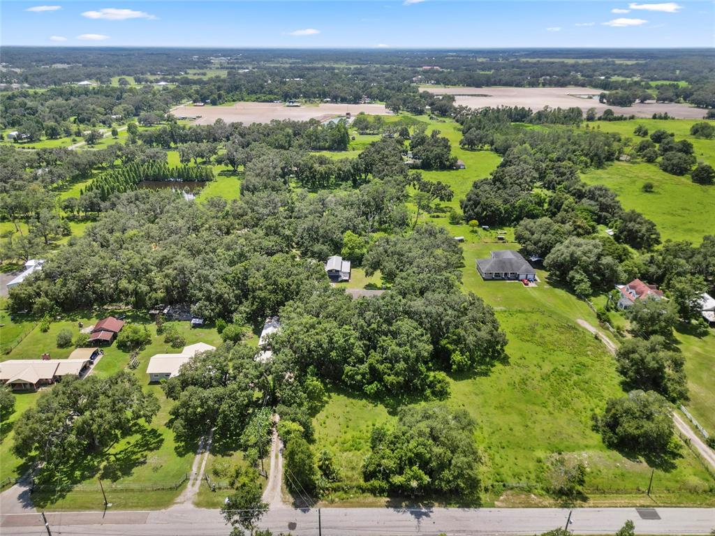 4405 North Wilder Road Plant City, FL 33565 - Photo 78 of 78 an aerial view of a residential houses covered in trees