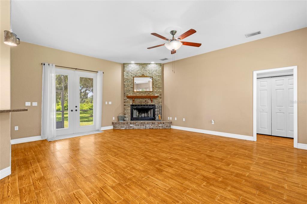 4405 North Wilder Road Plant City, FL 33565 - Photo 8 of 78 a view of an empty room with window and wooden floor