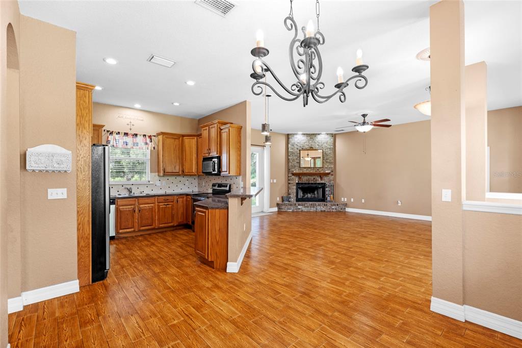 4405 North Wilder Road Plant City, FL 33565 - Photo 9 of 78 a view of kitchen and dining room with wooden floor