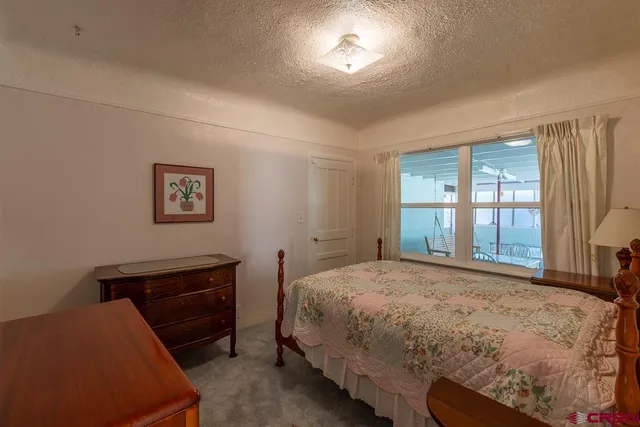 a bedroom with a bed and a lamp with window