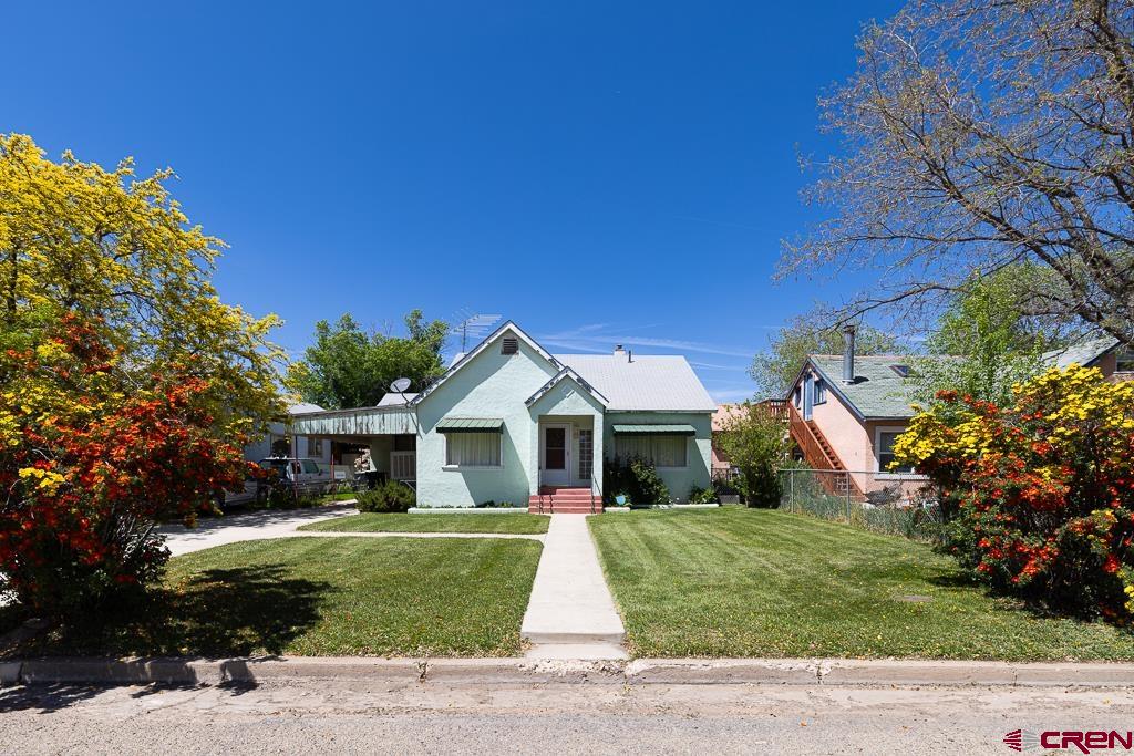 420 West 4th Street Cortez, CO 81321 - Photo 2 of 25 a front view of a house with a yard