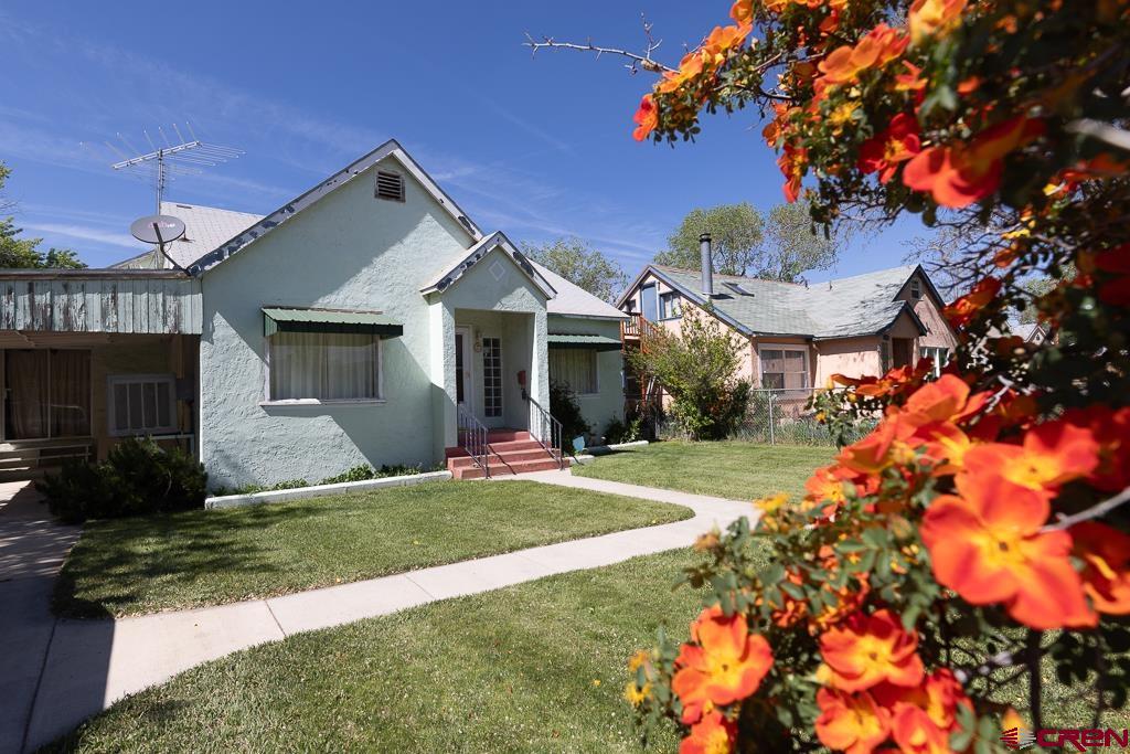 420 West 4th Street Cortez, CO 81321 - Photo 22 of 25 a front view of a house with a yard