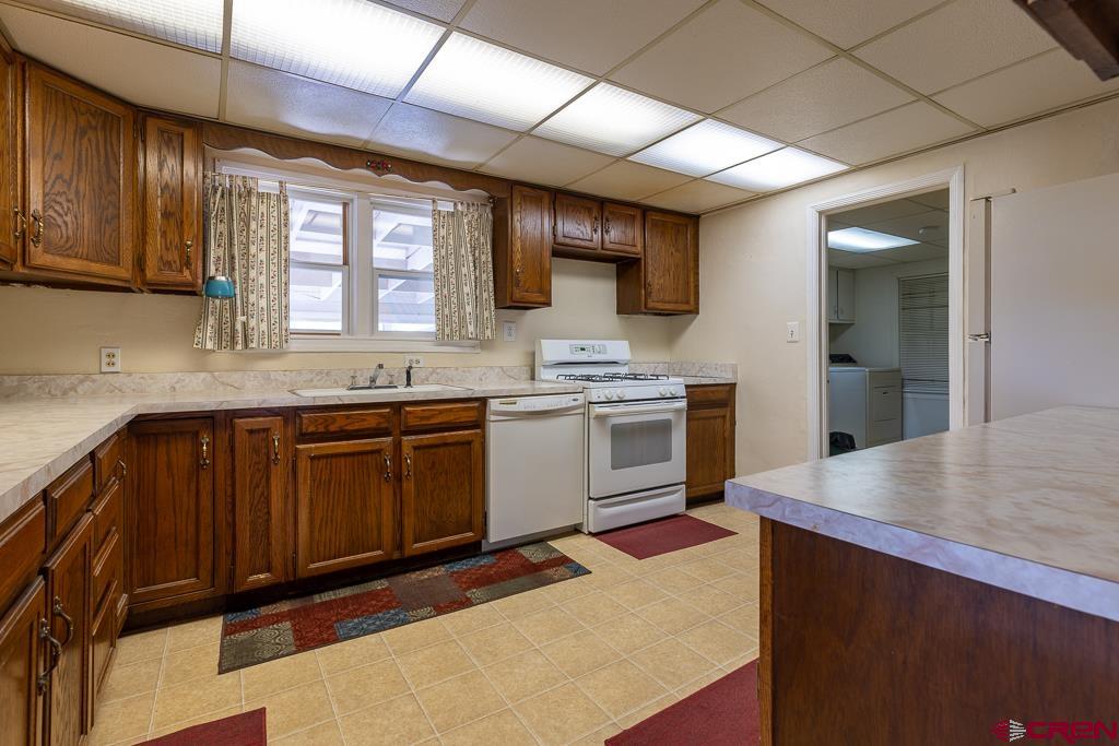 420 West 4th Street Cortez, CO 81321 - Photo 6 of 25 a kitchen with a stove a sink and a microwave