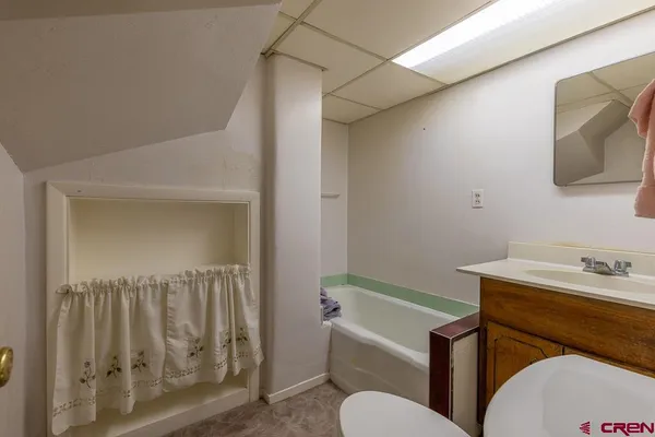 a bathroom with a sink toilet and mirror