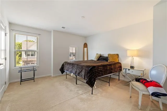 a bedroom with a bed chair and window