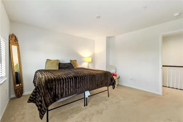 a bedroom with a bed and window