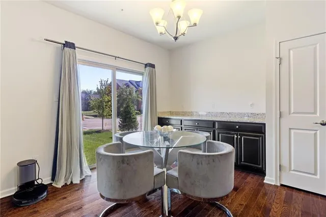 a dining room with furniture window and wooden floor