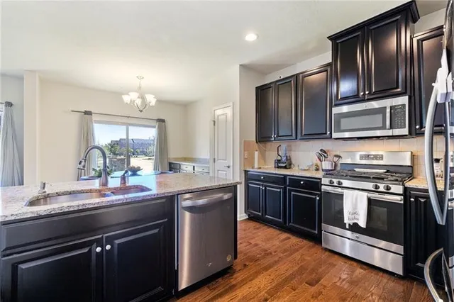 a kitchen with stainless steel appliances and sink