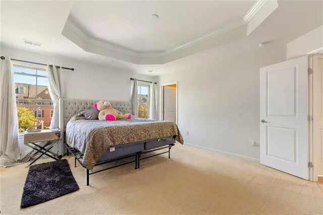 a bedroom with a large bed and a window