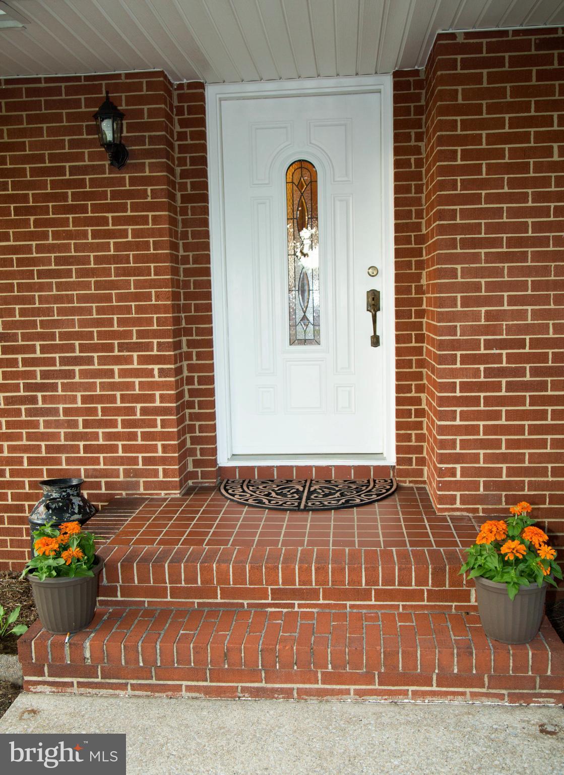1722 Severn Road Severn, MD 21144 - Photo 3 of 45 a view of a brick house with potted plants
