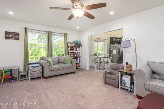 a living room with furniture and a large window